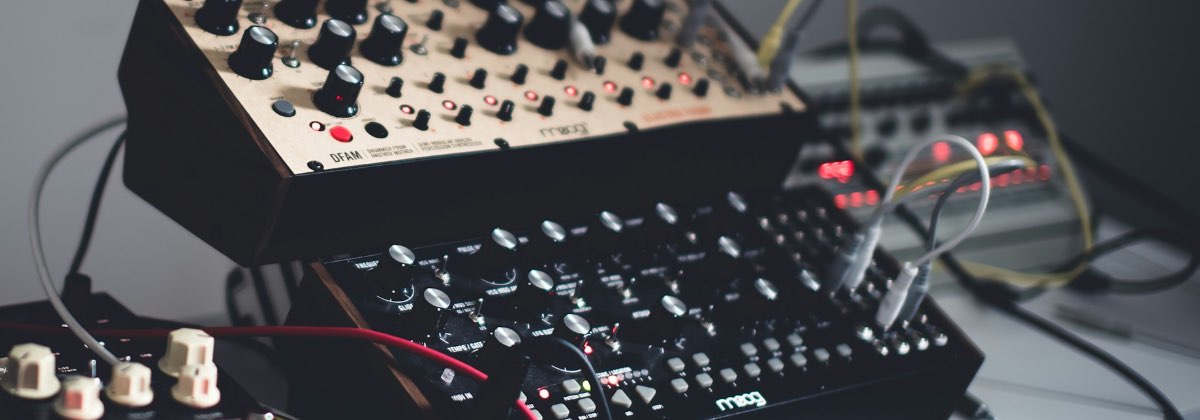 Close-up of the knobs and patch cables of a modular analog synthesizer