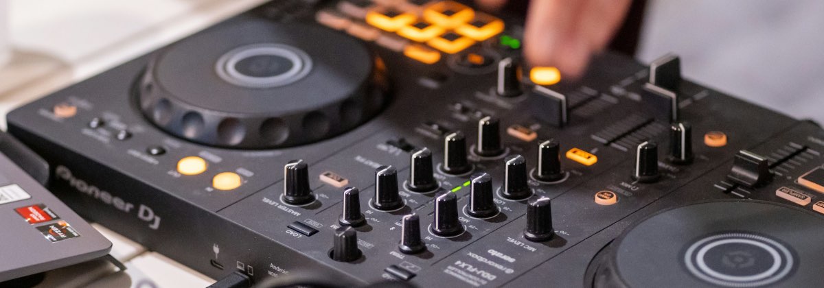 DJ mixing tracks on a controller during a live set
