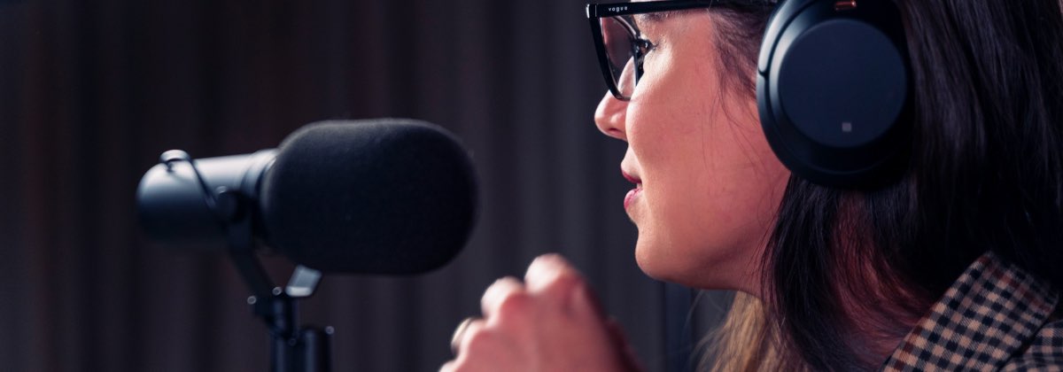 Podcaster speaking into a studio microphone