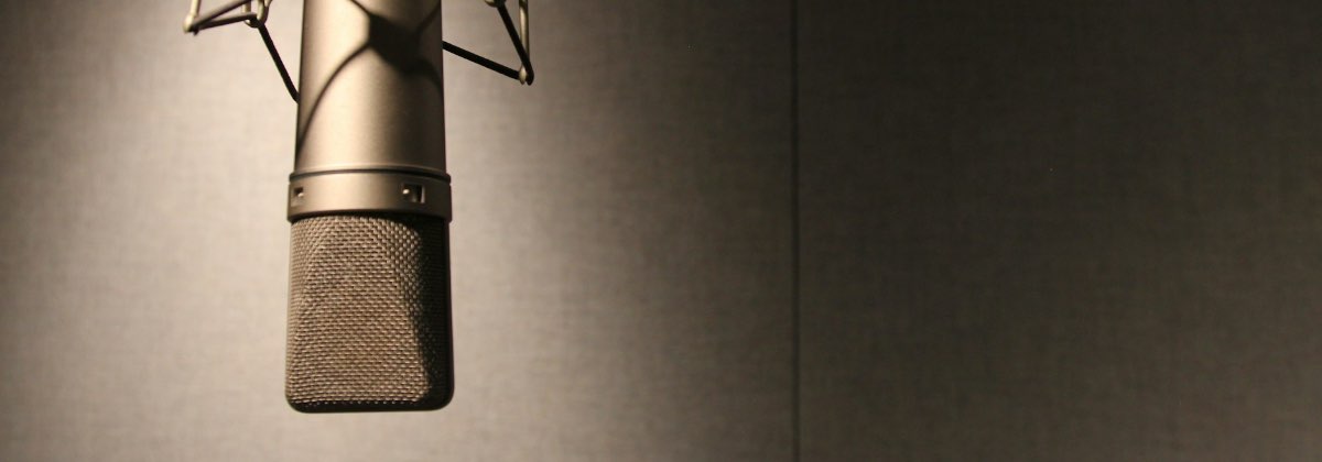 Podcast microphone in a studio with acoustic treatment