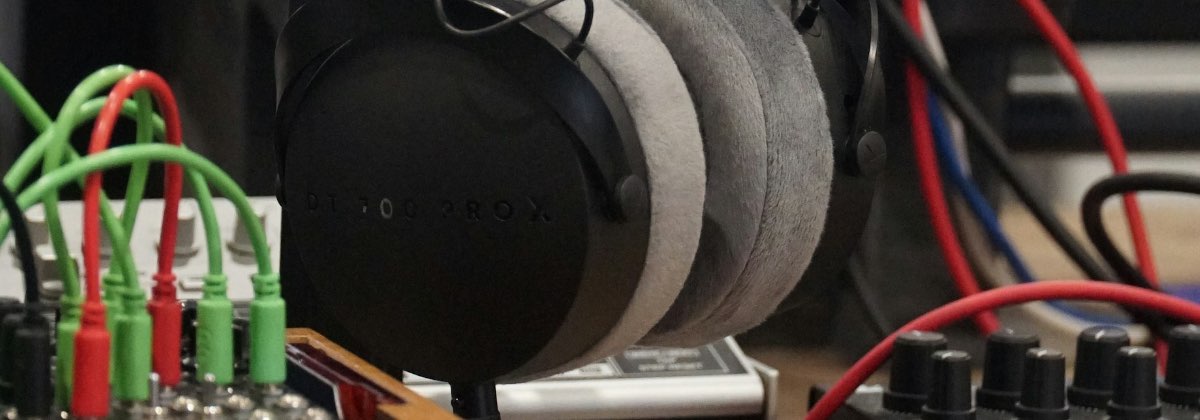 Audio engineer wearing studio headphones at a mixing console